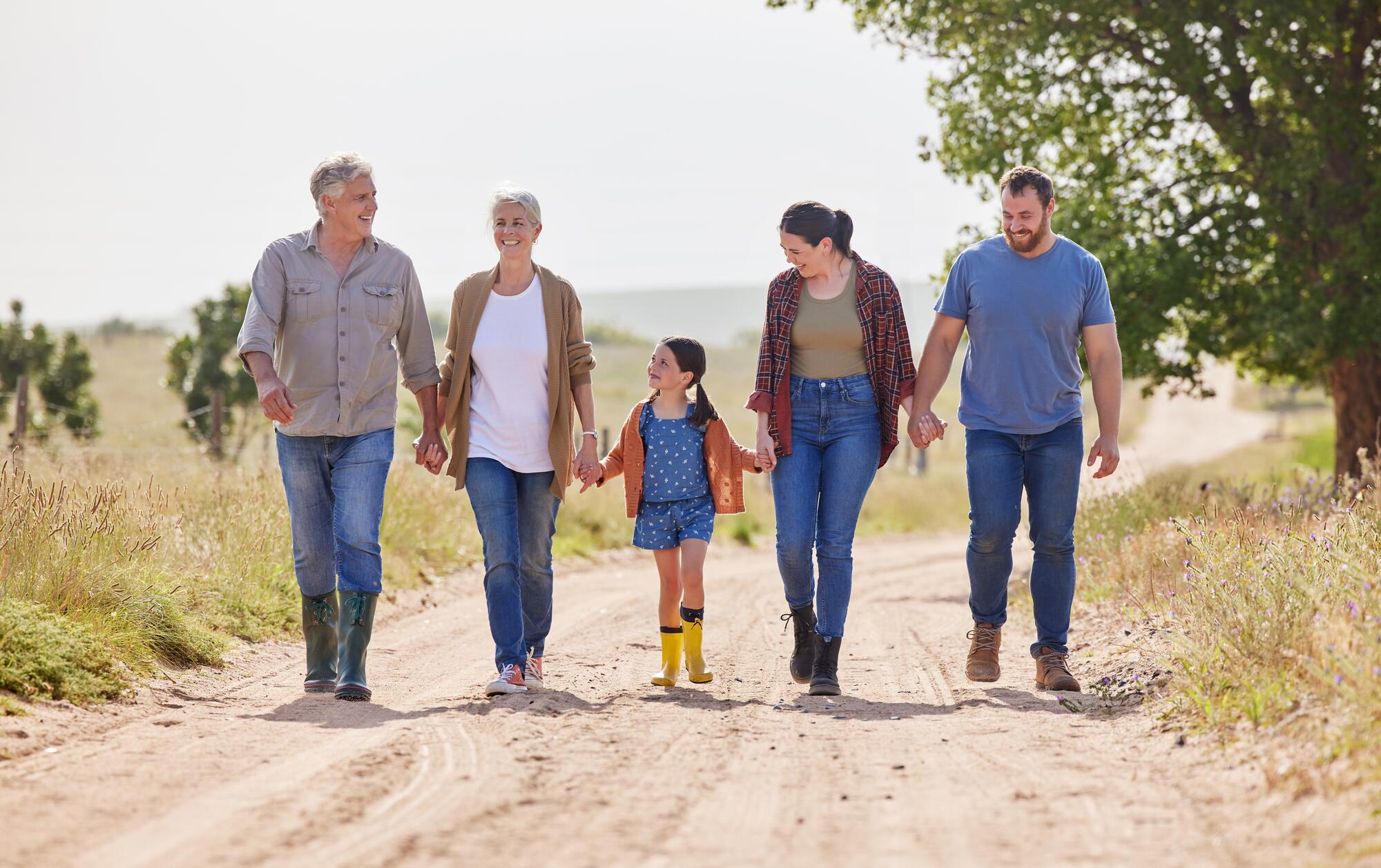 family of 3 generations walking together
